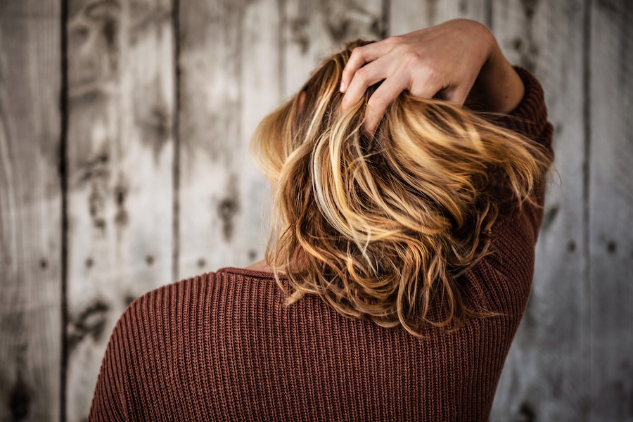 woman combing through hair